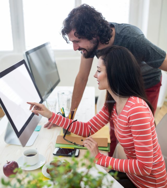 male-female-graphic-designers-interacting-computer